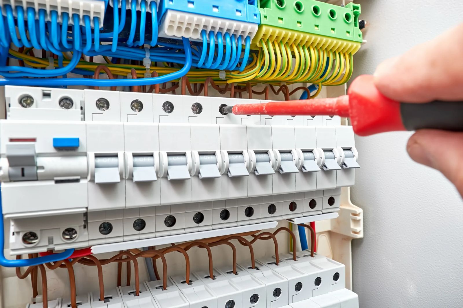 Professional electrician upgrading fuse box